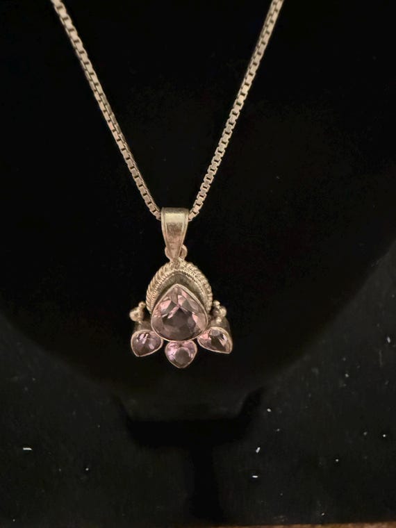 Vintage Paw Print sterling silver pendant featuring amethyst gemstone surrounded by smaller, heart-shaped stones.