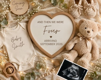 May include: A cream-colored baby bodysuit with the text Baby Smith, a heart-shaped wooden sign reading And then we were four arriving September 2026, a round Coming Soon sign, a tan teddy bear, crochet booties, a wooden rattle, and an ultrasound.