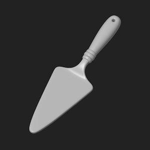 Puede incluir: Una espátula para pastel gris claro con una hoja triangular y un mango decorativo. El mango tiene un agujero en el extremo. La espátula está hecha de un material sólido y liso.