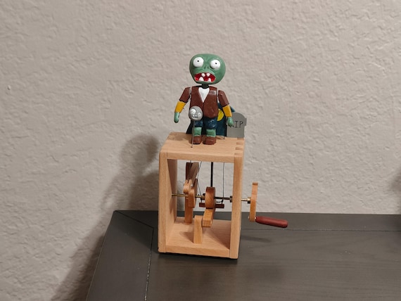 A hand-carved zombie automaton that moves with folk-art charm — weird, niche, and totally the kind of thing that sparks a conversation.