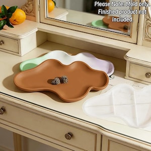 May include: Three cloud-shaped silicone molds for casting trays. One mold is brown, one is light green, and one is translucent white. The text 'Please Note: Mold only. Finished product not included.' is visible in the upper right corner.