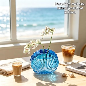 May include: A blue, shell-shaped silicone mold with a ribbed, fan-like texture and a circular opening at the top. The text "Please Note: Mold only. Finished product not included." is visible in the upper right corner of the image.