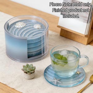 May include: A clear plastic cylindrical holder containing four round blue coasters with a glittery finish and seashell accents. The text "Please Note: Mold only. Finished product not included." is visible at the top of the image.