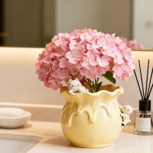 May include: A white ceramic mug with a black handle and the text "But First, Coffee" in a black, bold font. The mug is sitting on a white surface.