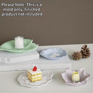 May include: A silicone mold for creating leaf-shaped dishes. The image displays four finished examples: a light green dish with a candle, a light blue dish, a white dish with a cake slice, and a light purple dish with a flower. Text reads: Please Note: This is a mold only, finished product not included.