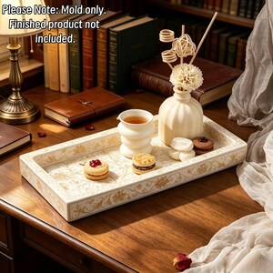 May include: A rectangular tray featuring a cream-colored base with intricate gold floral patterns. The tray holds a white ribbed vase with a decorative flower, a white cup, and two sandwich cookies. Text reads: Please Note: Mold only. Finished product not included.
