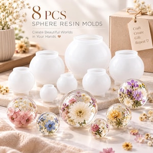 May include: A set of 8 translucent white silicone sphere resin molds in various sizes, accompanied by several finished clear resin spheres containing embedded dried flowers, with text reading 8 PCS SPHERE RESIN MOLDS and Craft Create Gift Repeat.