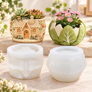May include: Two silicone molds for planters, one with a cottage house design and one with a cabbage leaf texture, displayed alongside two finished resin planters containing a succulent and pink daisies respectively.