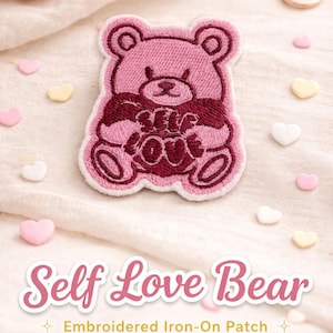 Puede incluir: Parche bordado rosa con diseño de oso y la frase "Self Love" en borgoña. La imagen incluye caramelos en forma de corazón en rosa, blanco y amarillo, y unas tijeras.