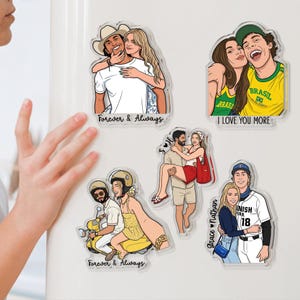 May include: Five clear acrylic magnets featuring illustrated couples. One shows a couple in a cowboy hat, another a couple in Brazil jerseys with 'I LOVE YOU MORE', one a couple on a yellow scooter, one a man carrying a woman, and one with 'Grace & Nathan'.