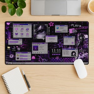 May include: A rectangular desk mat featuring a dark purple and black aesthetic with a retro computer interface design. The graphic includes multiple pop-up windows, a close-up of an eye, pixelated icons, the text 11:11, and various Japanese characters.