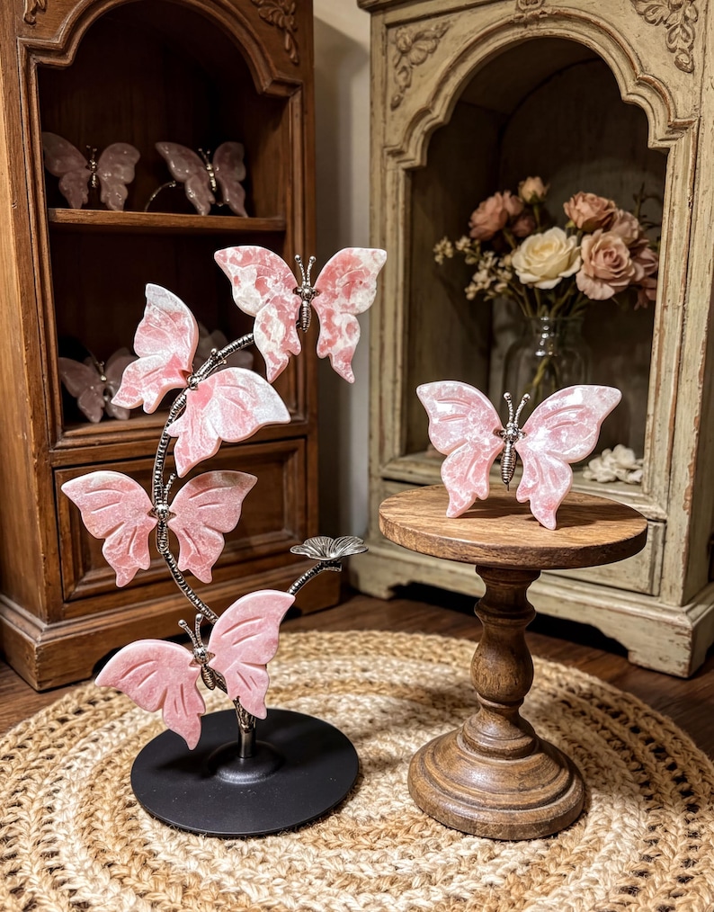 a decorative arrangement of pink butterfly figurines on a wooden stand, with a vase of flowers in the background.