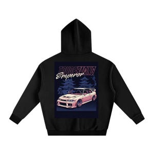 May include: Black hooded sweatshirt with a graphic on the back. The graphic features a pink and white car with the text "TOUGE RACING Emperor" in white and pink. The background includes stylized trees.