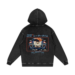 May include: Black hooded sweatshirt with a graphic on the back featuring a cartoon of a person sitting in front of a blue and white car with a cat. Text includes "TOUGE DRIVE" and Japanese characters.