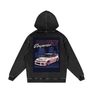 May include: Black hooded sweatshirt with a graphic on the back. The graphic features a white car with pink accents, the text "TOUGE RACING Emperor", and a forest background. The sweatshirt is made of a soft, comfortable material.