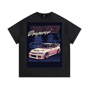 May include: Black t-shirt featuring a graphic of a pink and white sports car with the text "TOUGE RACING Emperor" above it. The design includes a forest silhouette and a checkered pattern.