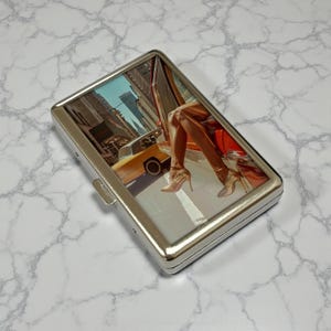 May include: A set of three ceramic mugs with a speckled, matte finish. The mugs are in shades of cream, light gray, and dark gray. Each mug has a simple, minimalist design, perfect for coffee or tea.