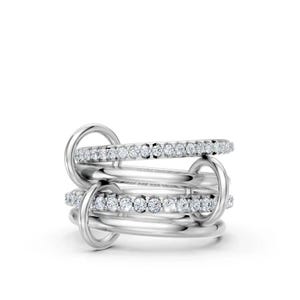May include: A multi-layered silver ring featuring two smooth polished bands and two bands encrusted with small clear round stones. The bands are interconnected by two vertical silver loops, creating a complex, layered, and dimensional structure.