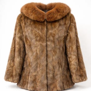 May include: A brown fur coat with a contrasting reddish-brown fur collar. The coat has a classic design with a button-up front and long sleeves. The fur appears soft and luxurious, suitable for cold weather.