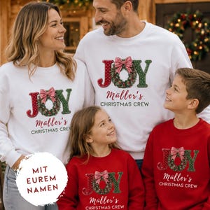 May include: Matching white and red crewneck sweatshirts featuring the text JOY with a wreath replacing the letter O, a red and white checkered bow, and the custom text M&uuml;ller's CHRISTMAS CREW printed in a dark green and red festive font style.