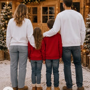 May include: Two adults and two children standing in a row, viewed from behind. The adults wear plain white crewneck sweatshirts and blue denim jeans. The two children wear plain red crewneck sweatshirts and blue denim jeans. All wear tan boots.