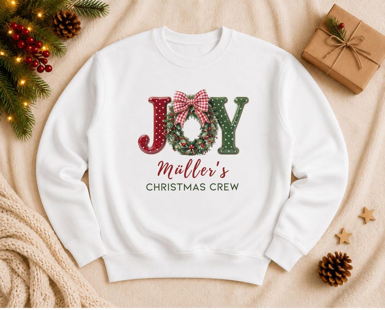 May include: A white crewneck sweatshirt featuring a graphic with the word JOY, where the O is replaced by a green wreath with a red and white gingham bow. Below the graphic, the text reads M&uuml;ller's CHRISTMAS CREW in red and dark green.