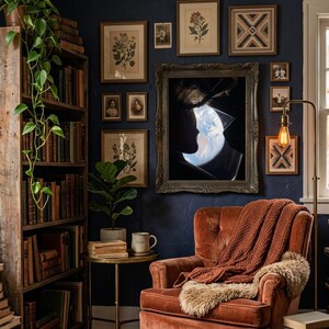 May include: A cozy reading nook with a dark blue wall, a wooden bookshelf, and a rust-colored armchair. The wall is adorned with framed botanical prints and a large framed artwork. A warm blanket and a faux fur throw are draped over the chair.