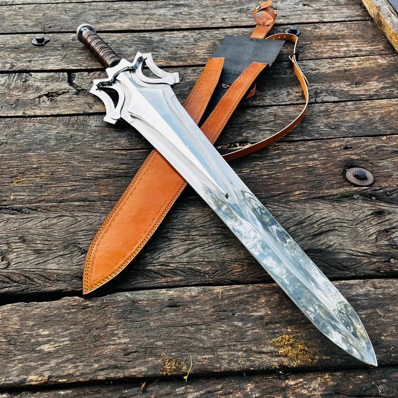 Full length handmade fantasy knife placed on wooden surface showing complete structure from blade to handle. The long blade and detailed guard create a strong visual impact. Suitable for collectors or as a premium gift for husband.