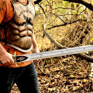 May include: A set of three ceramic mugs with a speckled, matte finish. The mugs are in shades of cream, light gray, and dark gray. Each mug has a simple, minimalist design, perfect for coffee or tea.