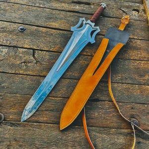 Artistic guard design close up showing unique curves and smooth finishing of the handmade knife. The design adds a bold character to the piece, making it stand out as a collector item or gift.