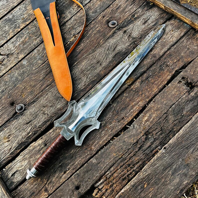 Diagonal display of fantasy sword style knife highlighting the artistic guard and long blade design. The composition emphasizes the unique shape and overall craftsmanship. This handmade piece is perfect for display collections or as a meaningful gift.