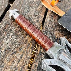 Close up view of the long blade highlighting its polished surface and clean edge geometry. The reflective steel finish enhances the premium feel while showcasing craftsmanship details. This handmade fantasy knife is suitable for display, collection, or gifting purposes, especially for those who value unique handmade pieces.