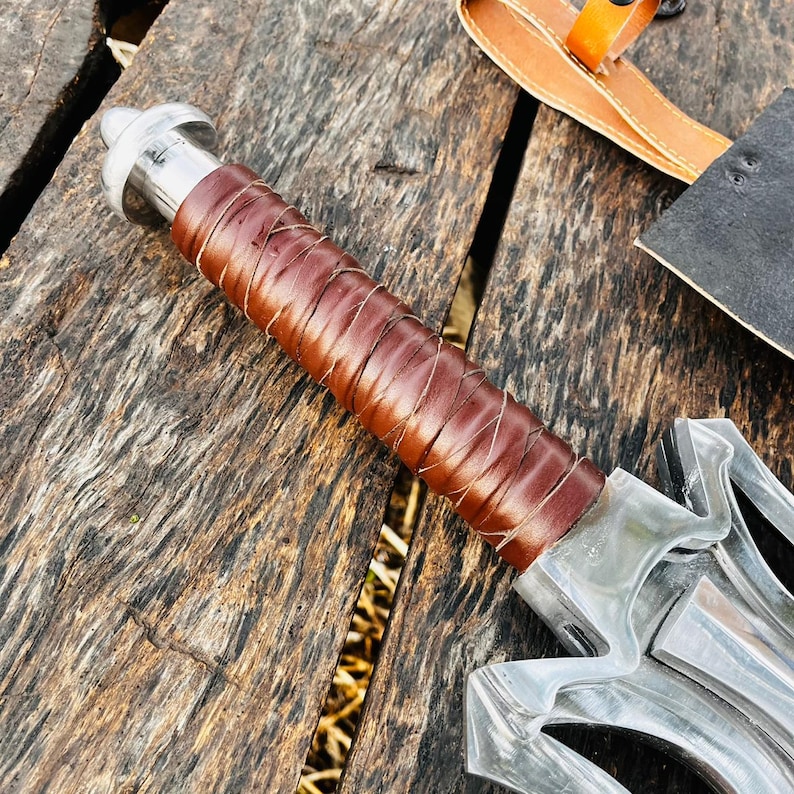 Close up view of the long blade highlighting its polished surface and clean edge geometry. The reflective steel finish enhances the premium feel while showcasing craftsmanship details. This handmade fantasy knife is suitable for display, collection, or gifting purposes, especially for those who value unique handmade pieces.