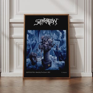 May include: A rectangular poster in a wooden frame featuring the Suffocation band logo in white at the top. The central artwork depicts a dark, blue-toned cavernous landscape with surreal figures. Text at the bottom reads: Suffocation - Breeding The Spawn, 1993, D. Seagrave.