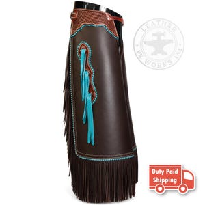May include: Dark brown leather chaps featuring a basket-weave pattern at the waist, turquoise piping, and long brown fringe along the side. The design includes a decorative turquoise leather inlay with matching fringe accents and silver studs.