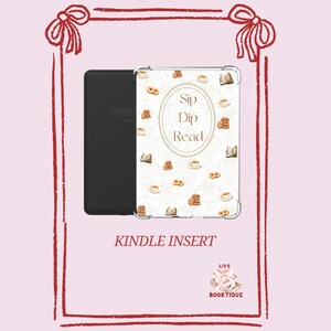 May include: Kindle insert with a white cover adorned with coffee cups, biscuits, and books. The text "Sip Dip Read" is in the centre. The words "Kindle Insert" are at the bottom.