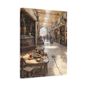 May include: A canvas print depicting a bustling Middle Eastern marketplace with stone arches and sunlight streaming through overhead openings. In the foreground, a wooden table holds tea glasses, a metal bowl, and food, while people walk through the corridor.