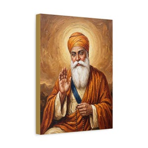 May include: A canvas print depicting a religious figure with a white beard and orange turban. The figure wears an orange robe and a blue sash, with a golden halo. The background is a warm, golden hue.