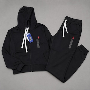 May include: A black zip-up hooded sweatshirt and matching sweatpants set. The hoodie features a white drawstring, a blue Polo Ralph Lauren tag, and a red embroidered horse logo. The sweatpants have a white drawstring and a red horse logo.