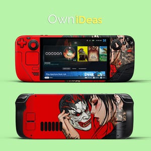 Może przedstawiać: Czerwono-czarna przenośna konsola do gier z ekranem wyświetlającym grę "cocoon" i tekst "Play Aperture Desk Job". Konsola ma czarno-biały wzór z tyłu z twarzą kobiety i maską.