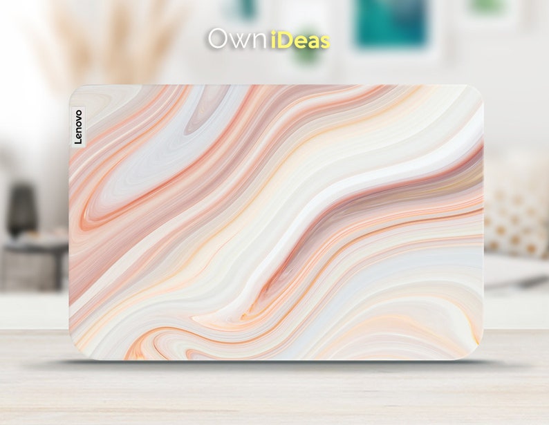 May include: A white laptop skin with a swirling pattern of peach, pink, and brown. The skin has the word "Lenovo" printed on the left side.