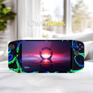 May include: A black handheld gaming device with a screen displaying a sunset scene and a circular logo. The device is decorated with a blue and green octopus tentacle design. The text "OwniDeas" is visible.