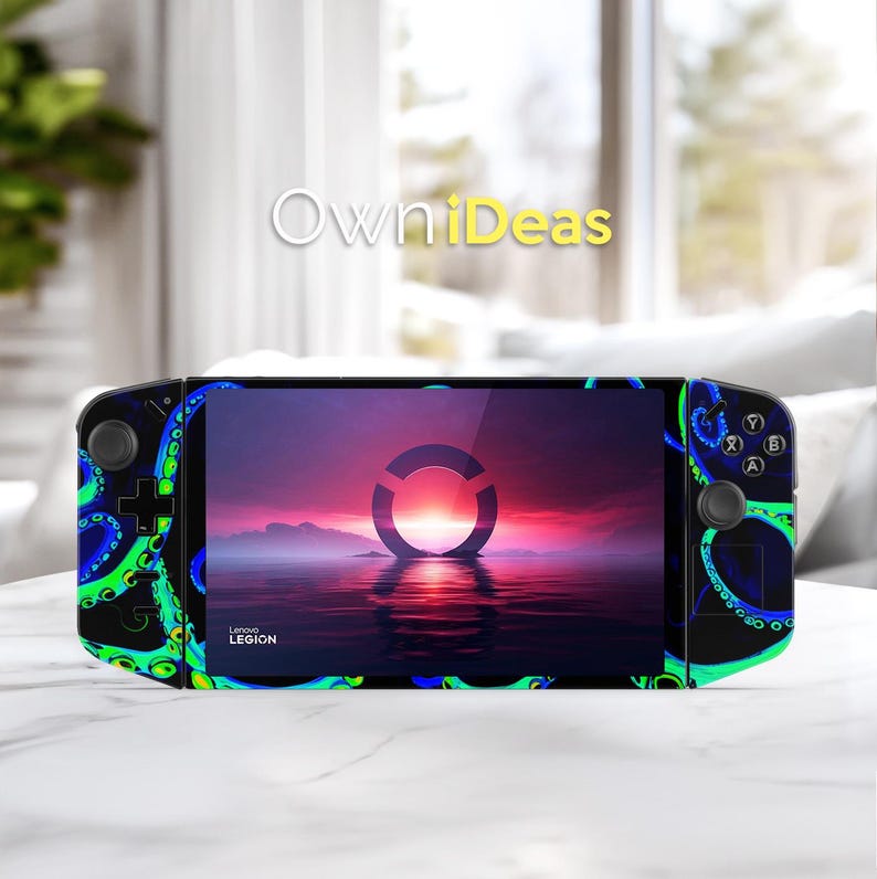 May include: A black handheld gaming device with a screen displaying a sunset scene and a circular logo. The device is decorated with a blue and green octopus tentacle design. The text "OwniDeas" is visible.