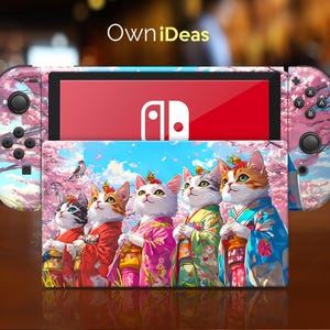 May include: A pink and white Nintendo Switch case with a floral design and a picture of five cats wearing kimonos. The case has the text "OwnIdeas" on the top.