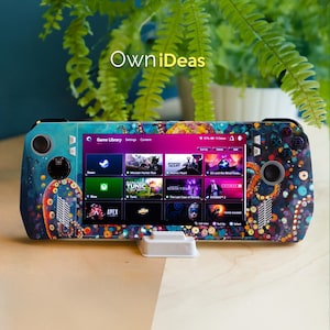 May include: A handheld gaming console with a colorful, artistic design featuring an octopus motif. The screen displays a game library with various game titles. The text "OwniDeas" is visible on the top of the console.