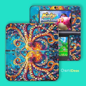 May include: A Nintendo 3DS console with a vibrant, colorful octopus design. The design features shades of blue, purple, orange, and yellow. The screen displays the game "Kirby Planet Robobot". The console is open, showing the top and bottom screens.