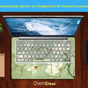 May include: A laptop keyboard with a green and white floral design. The keyboard is labelled "Lenovo". The text "Keyboard key stickers are Designed for US standard keyboards" is at the top of the image. The text "Own iDeas" is at the bottom of the image.