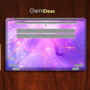May include: Purple laptop skin with a marble pattern and gold accents. The skin has a subtle shimmer and a galaxy-like design. The text "OwnIdeas" is printed on the top of the skin.