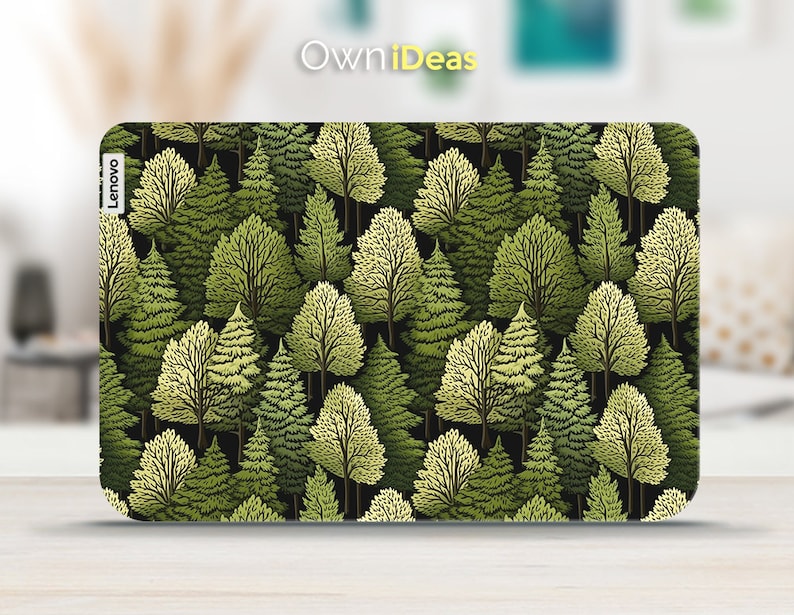 May include: A laptop skin with a repeating pattern of green trees on a black background. The skin has the word "Lenovo" printed on the side.