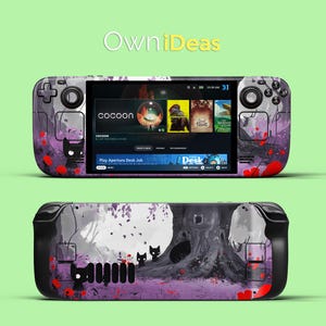 May include: A handheld gaming device with a purple and grey design featuring a stylised tree and black cats. The screen displays a game called "Cocoon" and a menu with other games like "Spiritfarer" and "The Wandering Village".